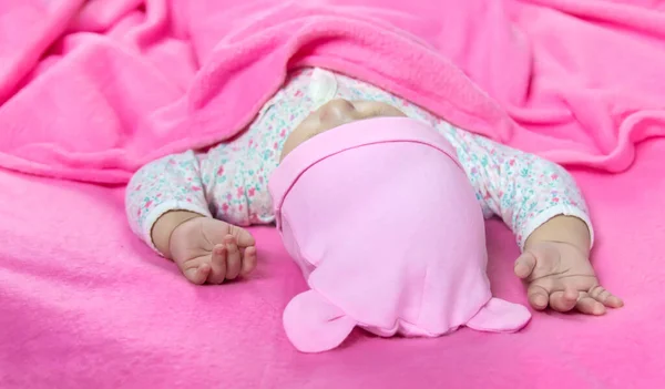 Baby sleeps on a pink bed. Selective focus. people.