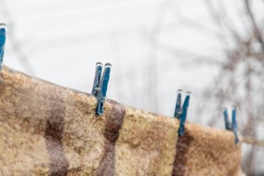 linen dries in winter covered with ice. selective focus. nature.