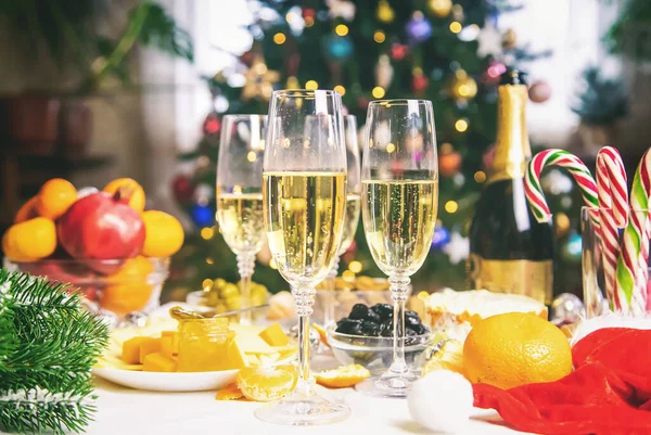 Christmas table with champagne and food. Selective focus. Holiday.