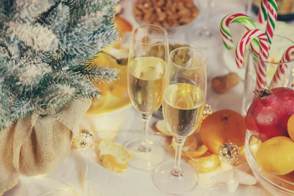 Christmas table with champagne and food. Selective focus. Holiday.