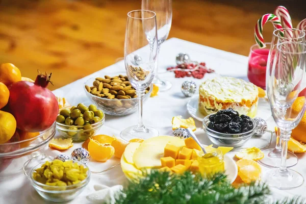 Christmas table with champagne and food. Selective focus. Holiday.