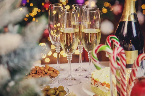 Christmas table with champagne and food. Selective focus. Holiday.