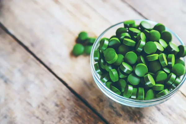 There are many spirulina and chlorella tablets. Selective focus. nature.