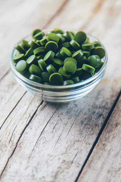 There are many spirulina and chlorella tablets. Selective focus. nature.