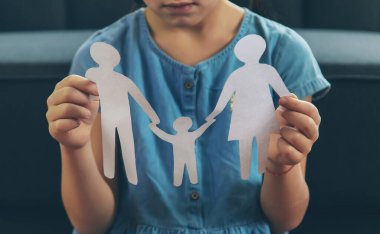 Elinde kağıttan bir aile olan bir çocuk. Boşanma, velayet ve çocuk istismarı kavramı. Seçici odaklanma. İnsanlar.