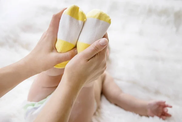 Mother Puts Socks Little Baby Selective Focus People — Stock Photo, Image