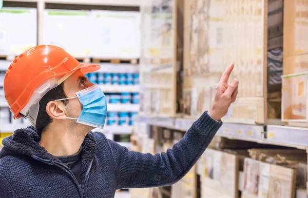 A man in a hardware store. Sells tiles. Selective focus. People.