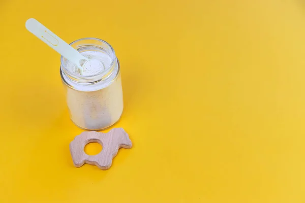 Baby milk and accessories on a yellow background. Selective focus. food.