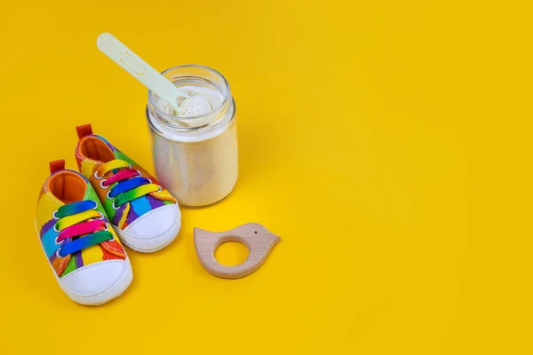 Baby milk and accessories on a yellow background. Selective focus. food.