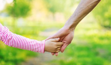 Babasıyla birlikte bir çocuk elden gider. Seçici odaklanma. Doğa.