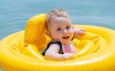 Bebek denizde bir çember içinde yüzüyor. Seçici odaklanma. Çocuk.