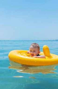 Bebek denizde bir çember içinde yüzüyor. Seçici odaklanma. Çocuk.