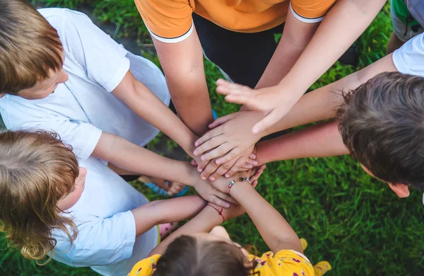 Children are playing with their hands clasped together. Selective focus. Kids.