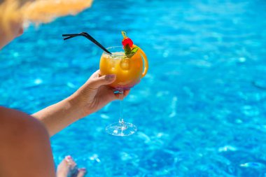 Havuzun yanında kokteyl içen kadın. Seçici odaklanma. İç..