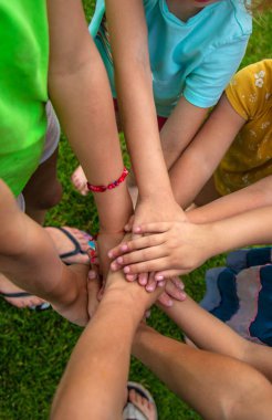 The children put their hands together. Selective focus. Kids.