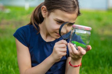 Doğada bir kertenkeleyle çocuk. Seçici odaklanma. Çocuk.
