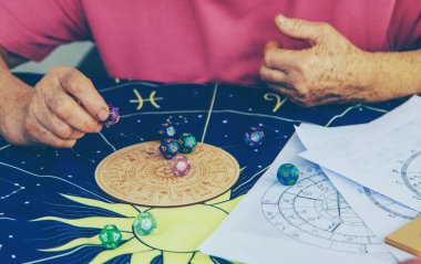 Woman numerologist astrologer counts numbers. Selective focus. People.