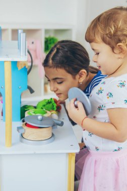 the child plays in the kitchen and cooks. Selective focus. Kid.