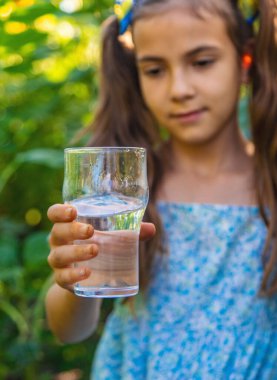 Çocuk bardaktan su içiyor. Seçici odaklanma. Çocuk.