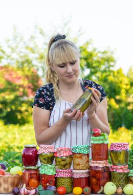 Woman with jar preserved vegetables for winter. Selective focus. Food.