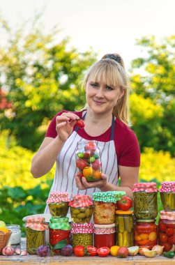 Woman with jar preserved vegetables for winter. Selective focus. Food.