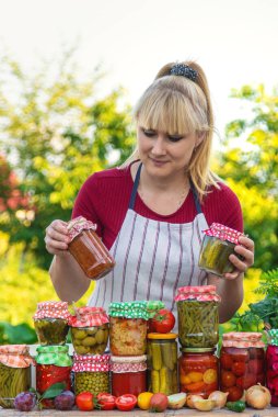 Woman with jar preserved vegetables for winter. Selective focus. Food.