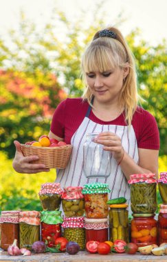 Woman with jar preserved vegetables for winter. Selective focus. Food.