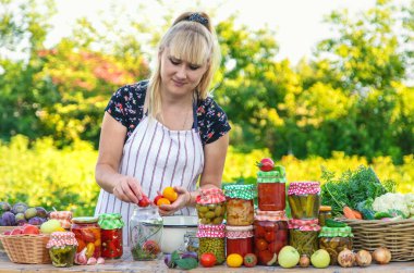 Woman with jar preserved vegetables for winter. Selective focus. Food.