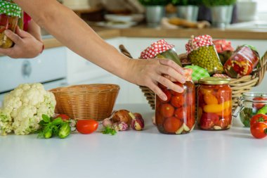 Woman jar preserve vegetables in the kitchen. Selective focus. Food.