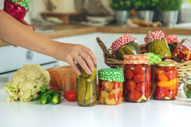 Woman jar preserve vegetables in the kitchen. Selective focus. Food.