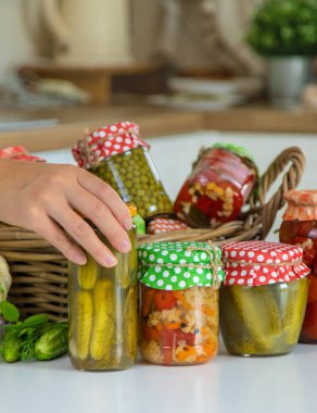 Woman jar preserve vegetables in the kitchen. Selective focus. Food.
