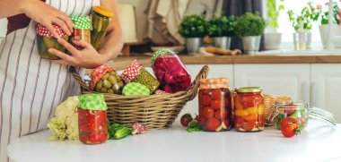 Woman jar preserve vegetables in the kitchen. Selective focus. Food.
