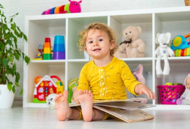 Children are reading a book in the room. Selective focus. Kid.