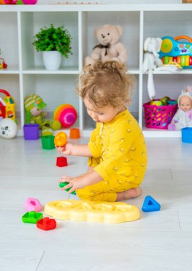 Children play with toys in the room. Selective focus. Kid.