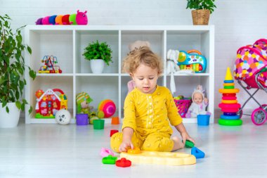 Children play with toys in the room. Selective focus. Kid.