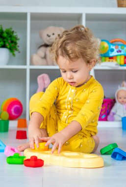 Children play with toys in the room. Selective focus. Kid.