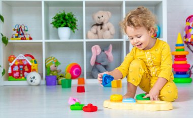 Children play with toys in the room. Selective focus. Kid.