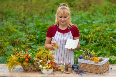 Medicinal herbs on the table. Place for notepad text. woman. Selective focus. nature.