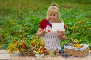 Medicinal herbs on the table. Place for notepad text. woman. Selective focus. nature.