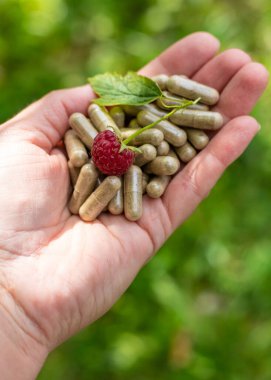Raspberry leaf extract and supplements. Selective focus. Food.
