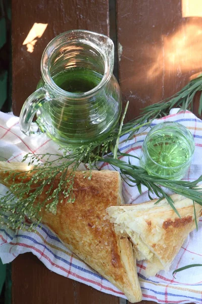 Puff pie with cheese and a drink of "Tarhun" — Stock Photo, Image