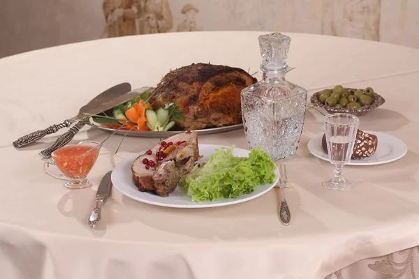 Pork stuffed with vegetables and a decanter of vodka — Stock Photo, Image