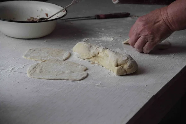 Female hands holding a piece of dough — Stock Photo, Image