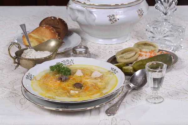 Soup with chicken and noodles and a glass of vodka — Stock Photo, Image