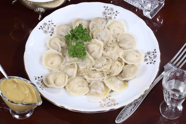 Dumplings with ground pepper, sour cream and vodka — Stock Photo, Image