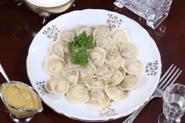 Dumplings with ground pepper, sour cream and vodka — Stock Photo, Image