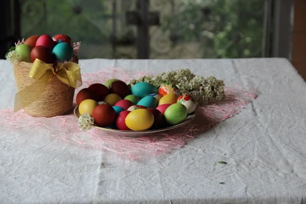 Oeufs peints dans un panier sur la table — Photo