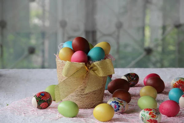 Easter eggs in different colors in a basket — Stock Photo, Image