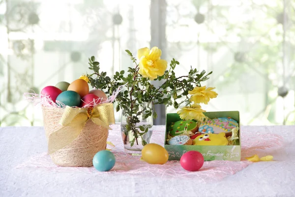 Easter cookies in a box and Easter eggs in a basket — Stock Photo, Image