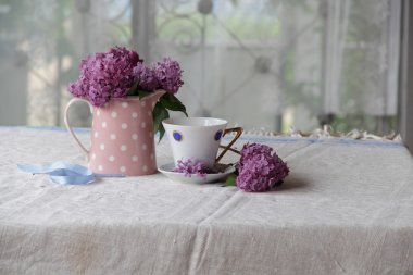 bir fincan çay ve leylak buket